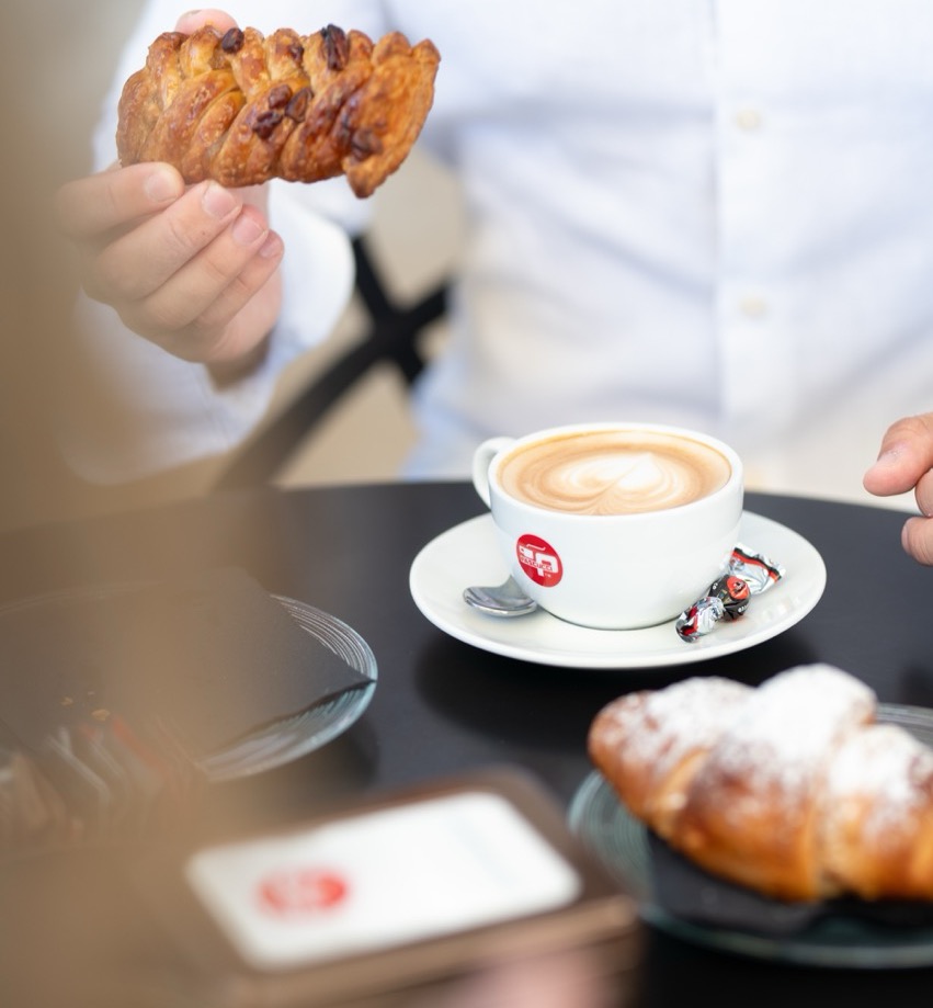 Golden pastry with cappuccino featuring beautiful latte art