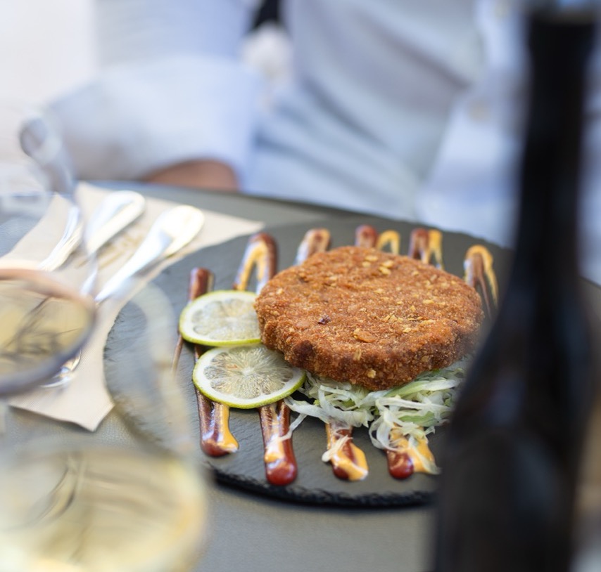 Elegant plated cutlet with lemon slices and garnish