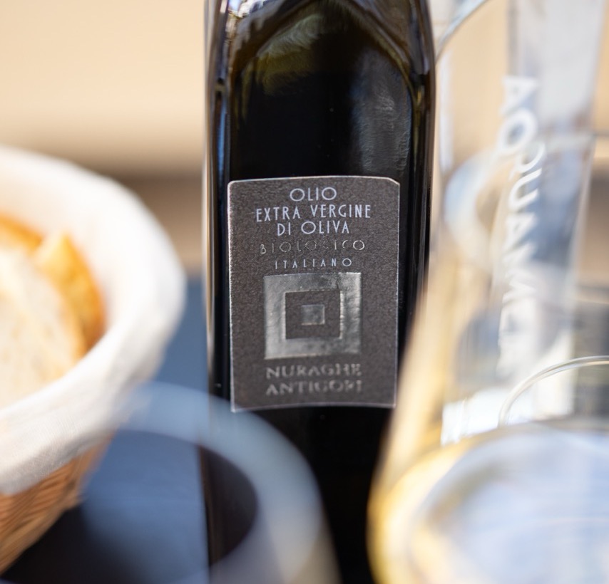 Nuraghe Antigori olive oil bottle with elegant table setting