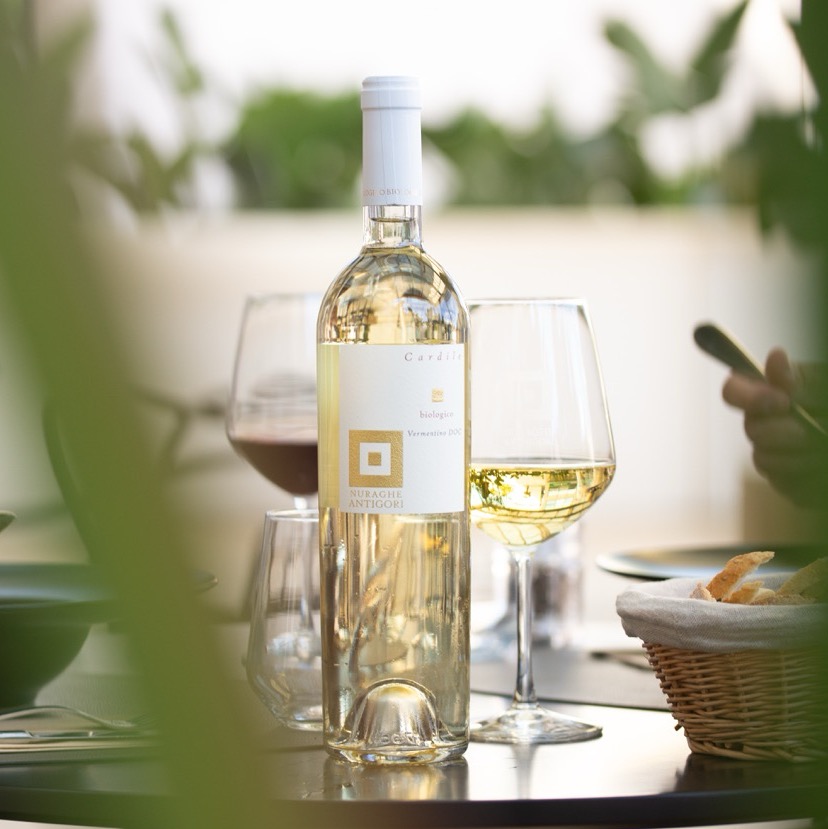 White wine bottle and glasses on outdoor dining table