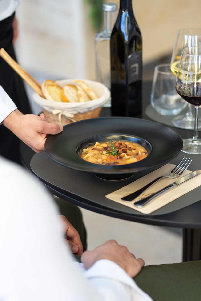Elegant restaurant service with beautifully plated dish and wine