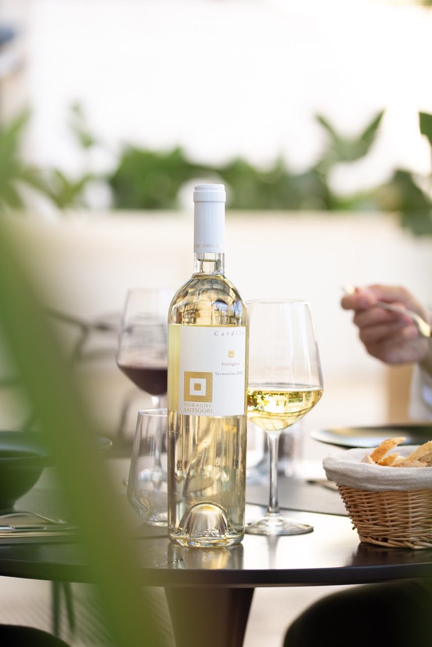 Elegant outdoor dining with white wine and table setting