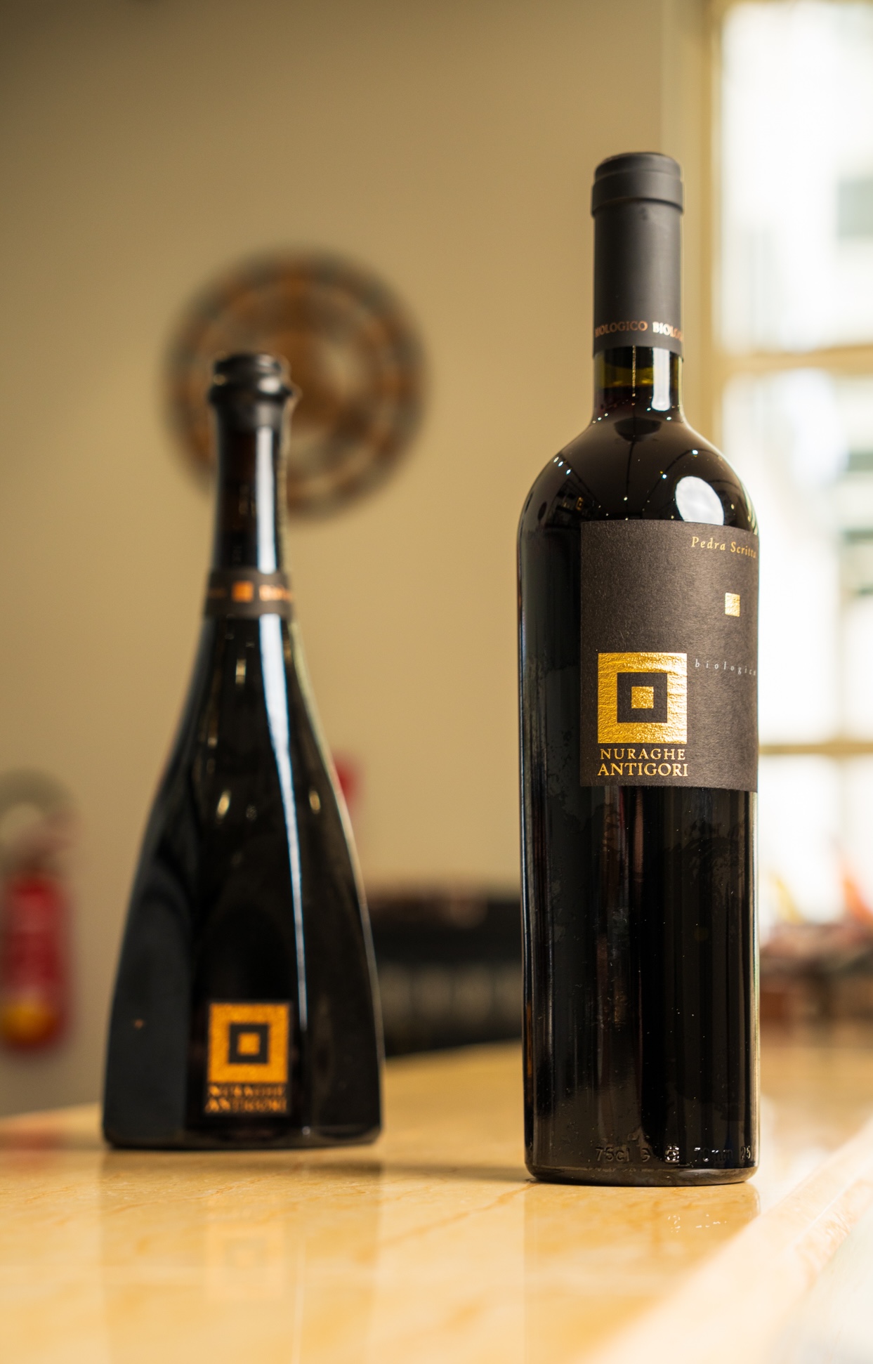 Nuraghe Antigori wine bottles on wooden surface